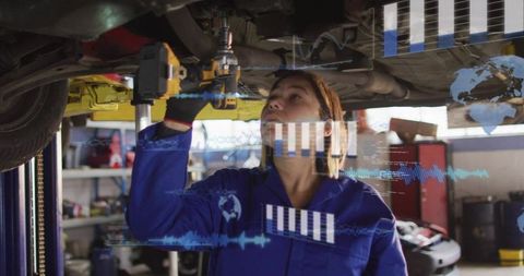 Female mechanic inspecting car undercarriage on lift using augmented reality diagnostics