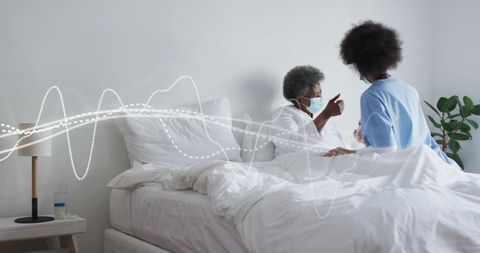 Senior patient pointing to nurse during home care visit with health waveform overlay