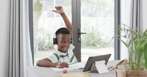 Boy Engaged in E-Learning at Home with Tablet and Headphones