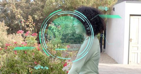 Woman using augmented reality garden interface with teal hud overlays
