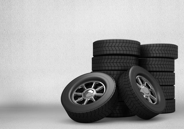 Digital composition of stack of tyres against grey background