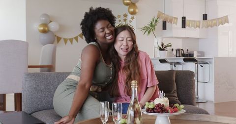Diverse Female Couple Celebrating Birthday with Joyful Embraces