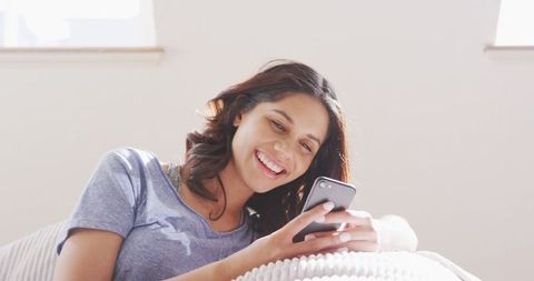 Smiling Woman Relaxing at Home Using Smartphone During Weekend - Download Free Stock Images Pikwizard.com