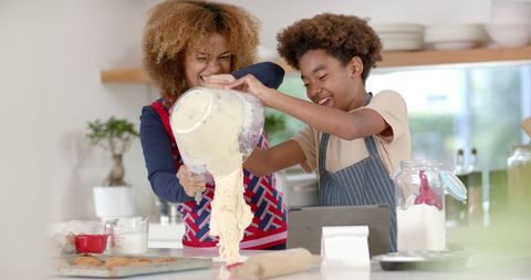 Mother and Son Baking with Joyful Expressions in Home Kitchen
