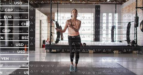 Jumping rope workout in industrial gym with stock market data overlay