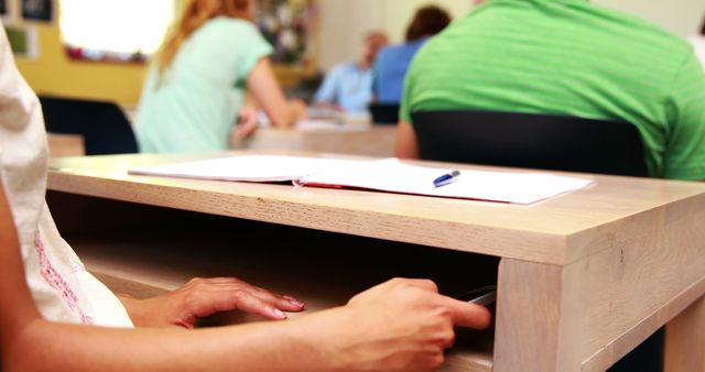 Student Hands Holding Smartphone Under Desk During Classroom Lesson - Download Free Stock Images Pikwizard.com