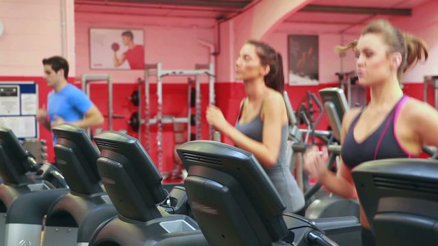 Individuals exercising on treadmills in a modern fitness center. This image emphasizes an active lifestyle and the importance of regular exercise. Ideal for marketing gym memberships, fitness equipment, or health and wellness campaigns.