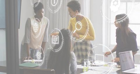 Leading diverse team in sunlit boardroom collaborating on strategy with laptop and notes