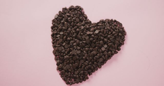 Heart-Shaped Arrangement of Chocolate Chips on Pink Background - Download Free Stock Images Pikwizard.com