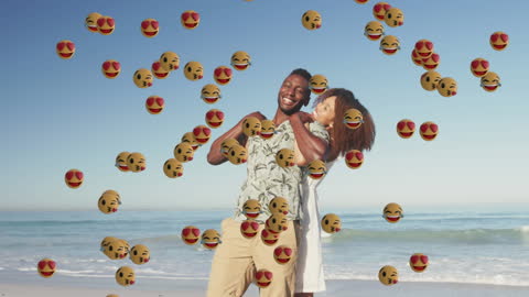 Playful Couple at Beach Overlaid with Emojis