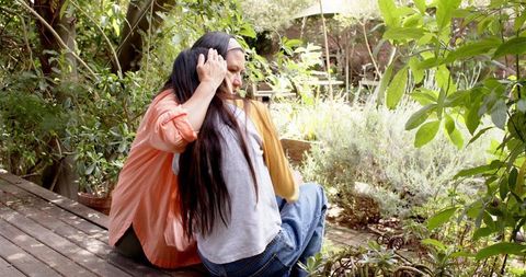 Mother and Daughter Embracing in Peaceful Garden Setting