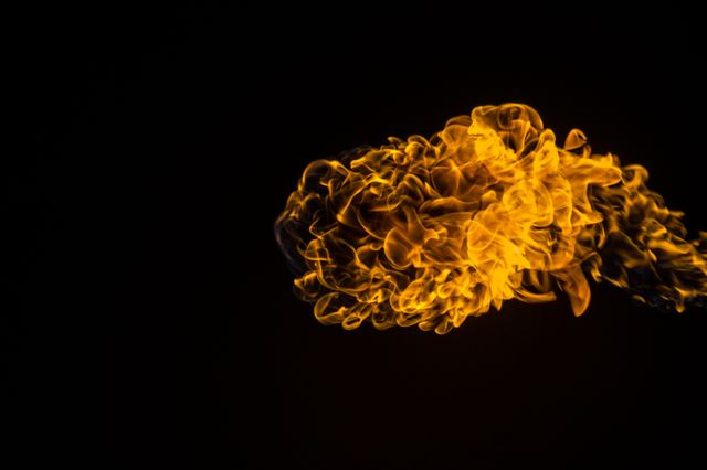Vibrant Yellow Fire Flame on Dark Background - Download Free Stock Photos Pikwizard.com