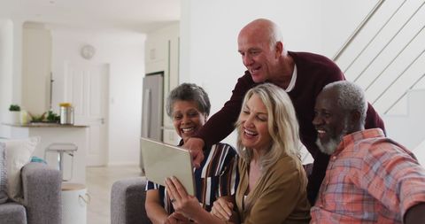 Joyful Seniors Socializing and Using Digital Tablet