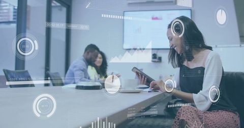 Businesswoman Analyzing Data on Tablet in Modern Conference Room