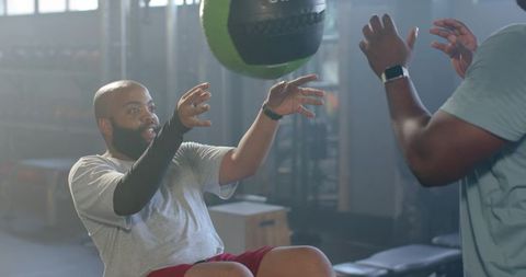 African american men doing medicine ball workout building core strength and teamwork