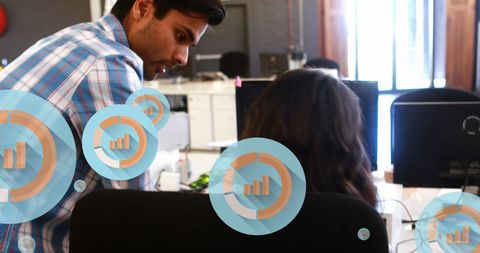 Colleagues Analyzing Data with Digital Interface in Modern Office