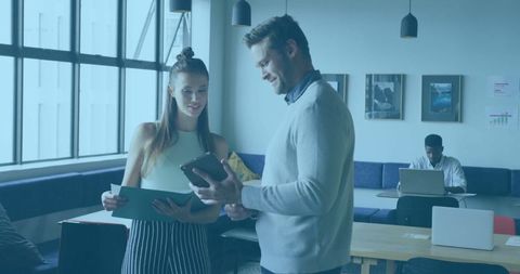 Two Professionals Collaborating in Modern Office Lounge