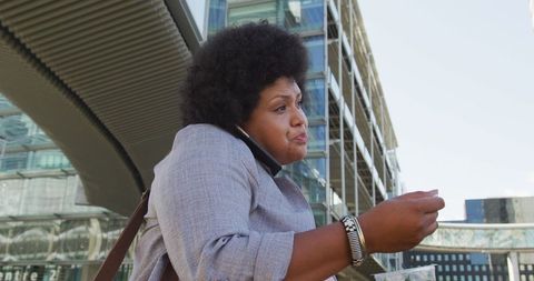 Busy Modern Lifestyle: Plus Size Woman Walking in City with Smartphone