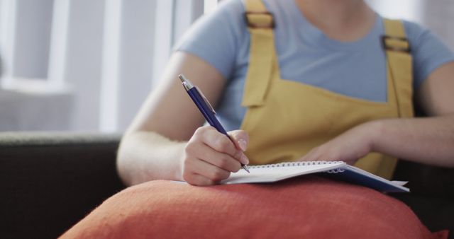 Woman in Casual Wear Writing in Notebook at Home - Download Free Stock Images Pikwizard.com