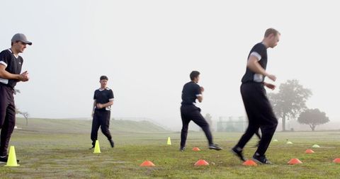 Athletes navigating agility drills in early morning