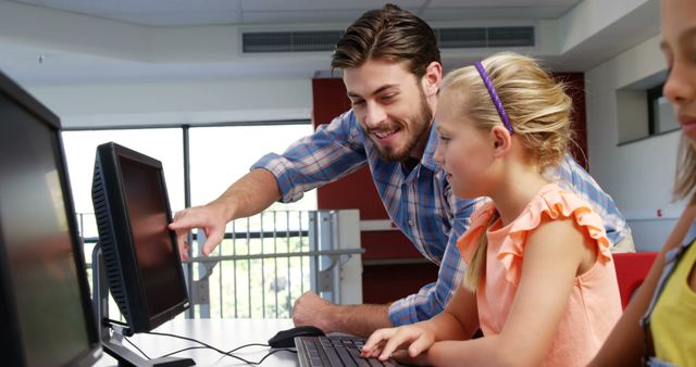 Teacher assisting schoolgirls in learning computer at school 4k - Download Free Stock Photos Pikwizard.com