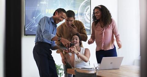 Diverse Team Collaborating in Office Celebrating Success