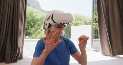 Senior Woman Engaging in Virtual Reality Technology Indoors