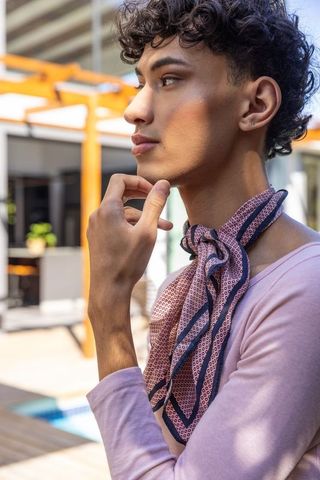 Stylish Young Man with Scarf Enjoying Tranquil Outdoor Setting