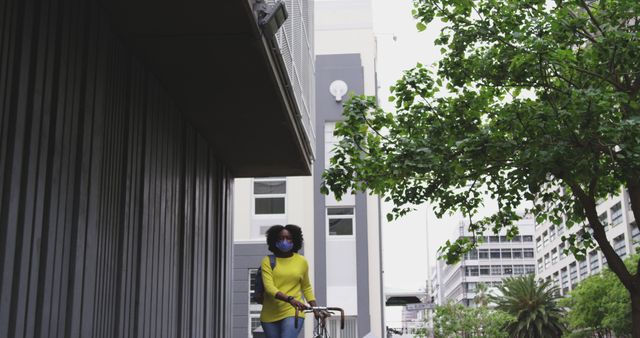 Woman Wearing Face Mask Walking with Bicycle in Urban Area - Download Free Stock Images Pikwizard.com