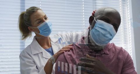 Clinician examining male patient neck while both wearing masks with medical data overlay