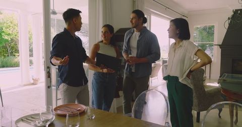 Friends Gathering in Bright Living Room Enjoying Conversation