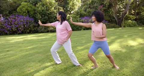 Mother and Daughter Tai Chi in Lush Garden Setting