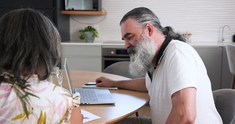 Senior Couple Practicing Financial Planning at Kitchen Table