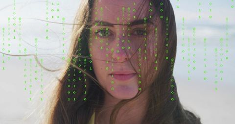 Young woman facing coastline windblown hair green binary code overlay digital identity