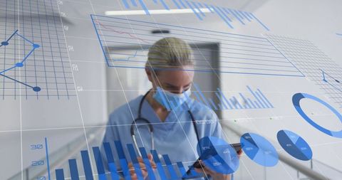 Nurse Analyzing Data with Technology in Hospital Corridor