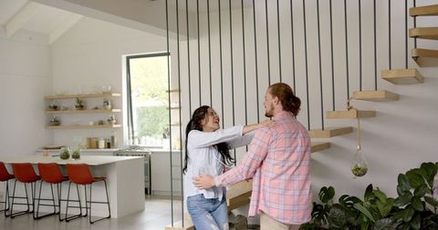 Playful Couple Enjoying Modern Kitchen