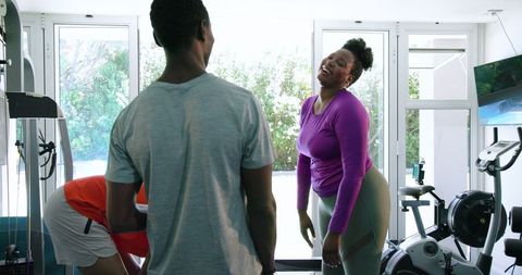 Fitness motivation with personal trainer at home gym