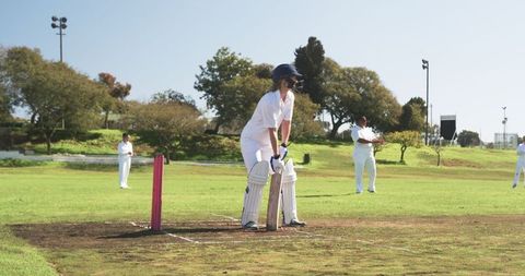 Female Cricket Player Ready at Bat in Competitive Match