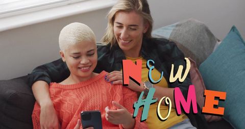 Happy Couple at New Home Using Smartphone Together