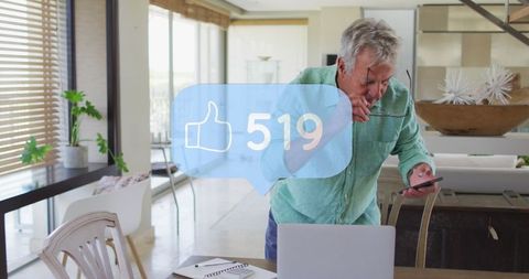 Senior Man Engaging with Digital Technology in Modern Home