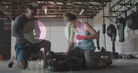 Female Athlete Training with Coach on Punching Bag Using Digital HUD in Industrial Gym