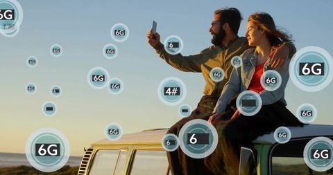 Couple taking selfie on vintage van roof at sunset with 6g connectivity overlay seaside