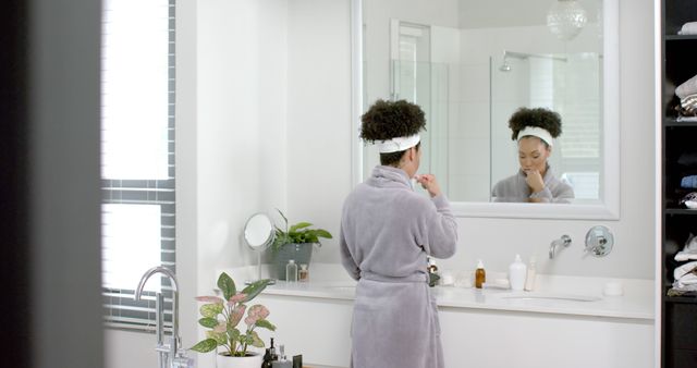 Woman in Bathrobe Standing in Modern Bathroom Brushing Teeth - Download Free Stock Images Pikwizard.com