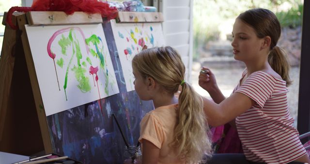 Two Girls Painting Together at Easel in Sunlit Room - Download Free Stock Images Pikwizard.com