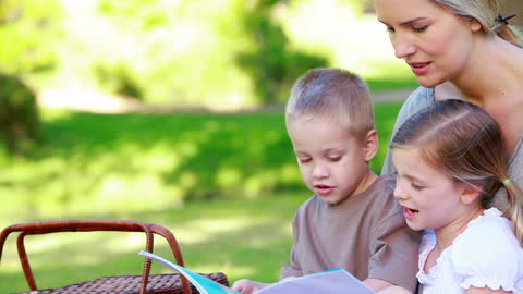 Mother Reading with Children at Outdoor Picnic