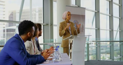 Diverse Team Attending Presentation in Modern Office