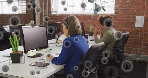 Customer support team working at open loft office with headsets and floating chat icons