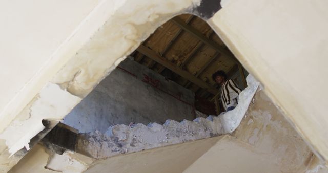 View of geometric triangle-shaped ceiling in dilapidated building. Urbex enthusiasts can use for exploring decay, architectural analysis, or background in storytelling.