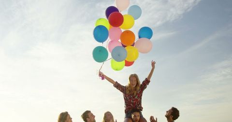 Joyful Celebration with Friends Holding Colorful Balloons Outdoors - Download Free Stock Images Pikwizard.com