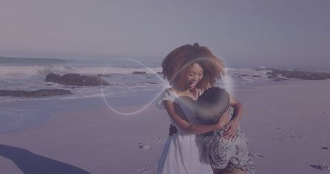 Sunlit beach embrace: young couple hugging by waves with soft pastel coastal light